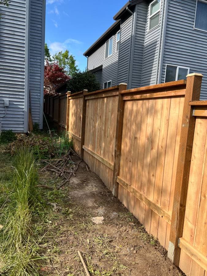 New cedar fence installation along residential property line