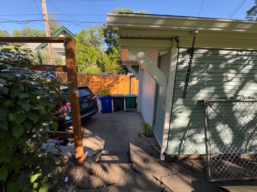 Fence repair and gate adjustment in progress at residential home